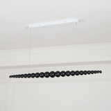 Black beaded chandelier hanging from a white ceiling