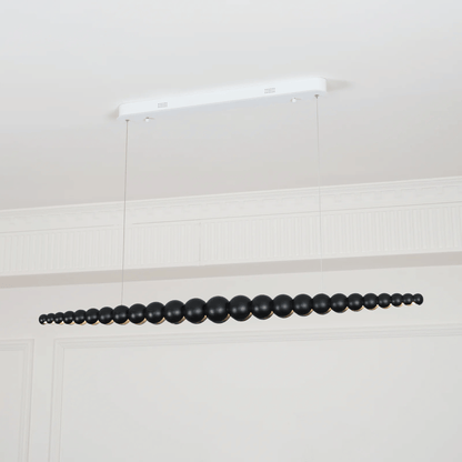 Black beaded chandelier hanging from a white ceiling