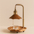 Decorative lamp with wooden base and brass fixture on a beige background