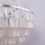 Chandelier with sheer white curtains on a plain background