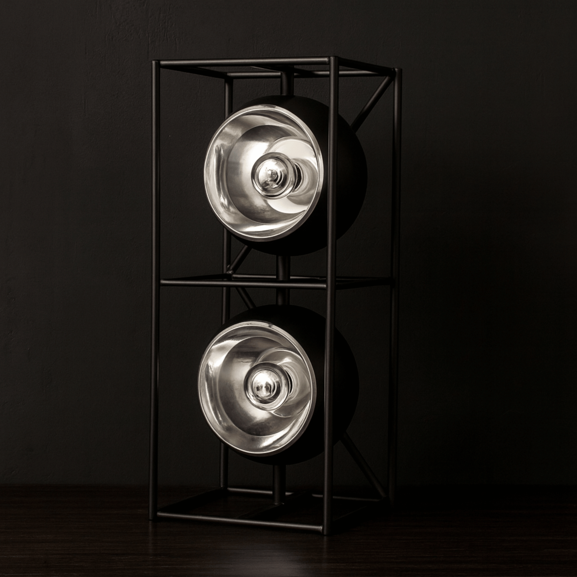 Modern floor lamp with two metallic light fixtures on a black background