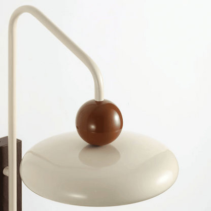 Decorative wall lamp with a brown sphere and beige arm on a white background