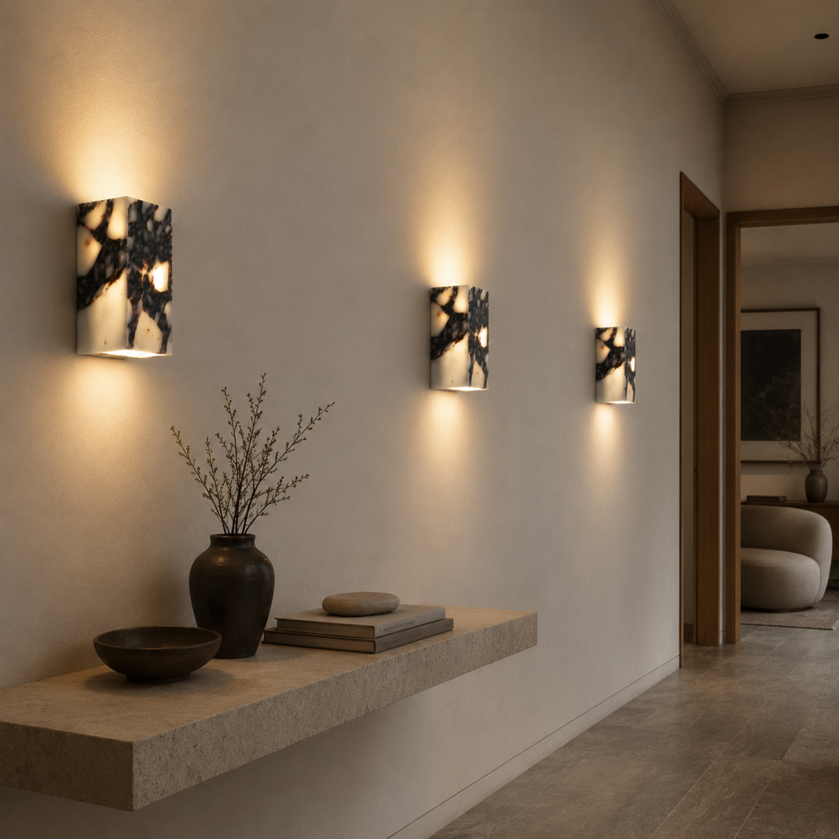 Modern interior with wall sconces, a floating shelf, and decorative items.