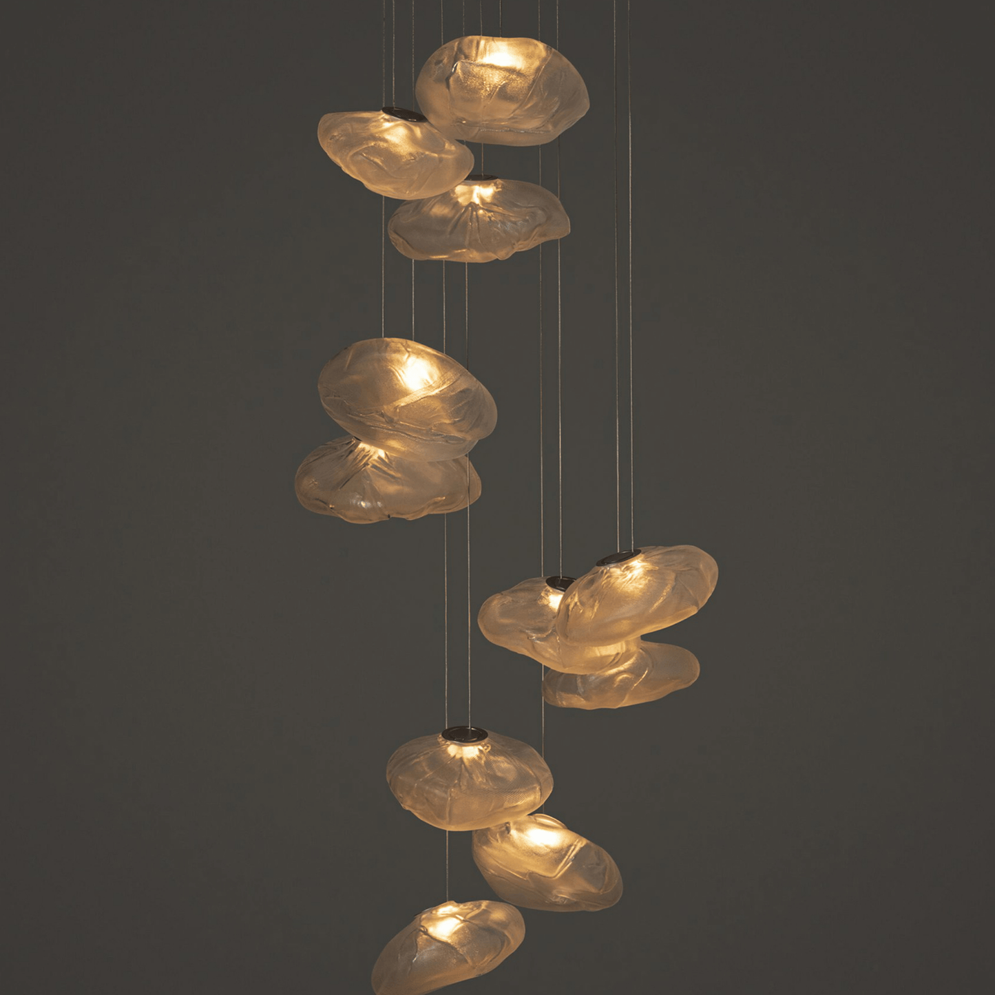 Decorative pendant light with glass shades on a dark background
