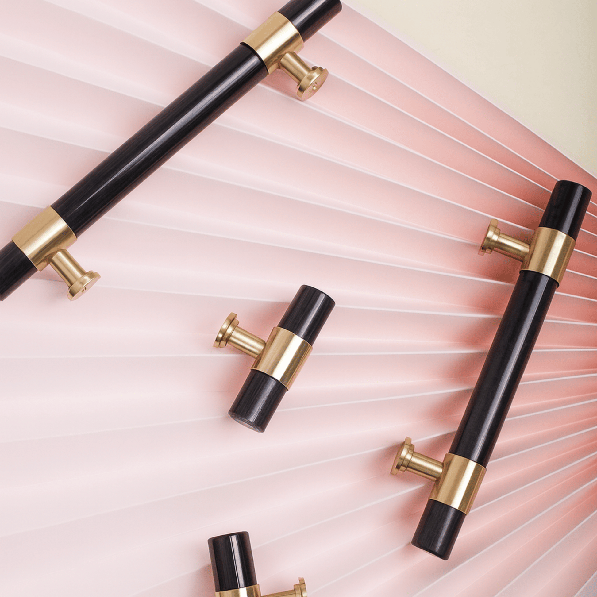 Black and gold handles on a pink textured background
