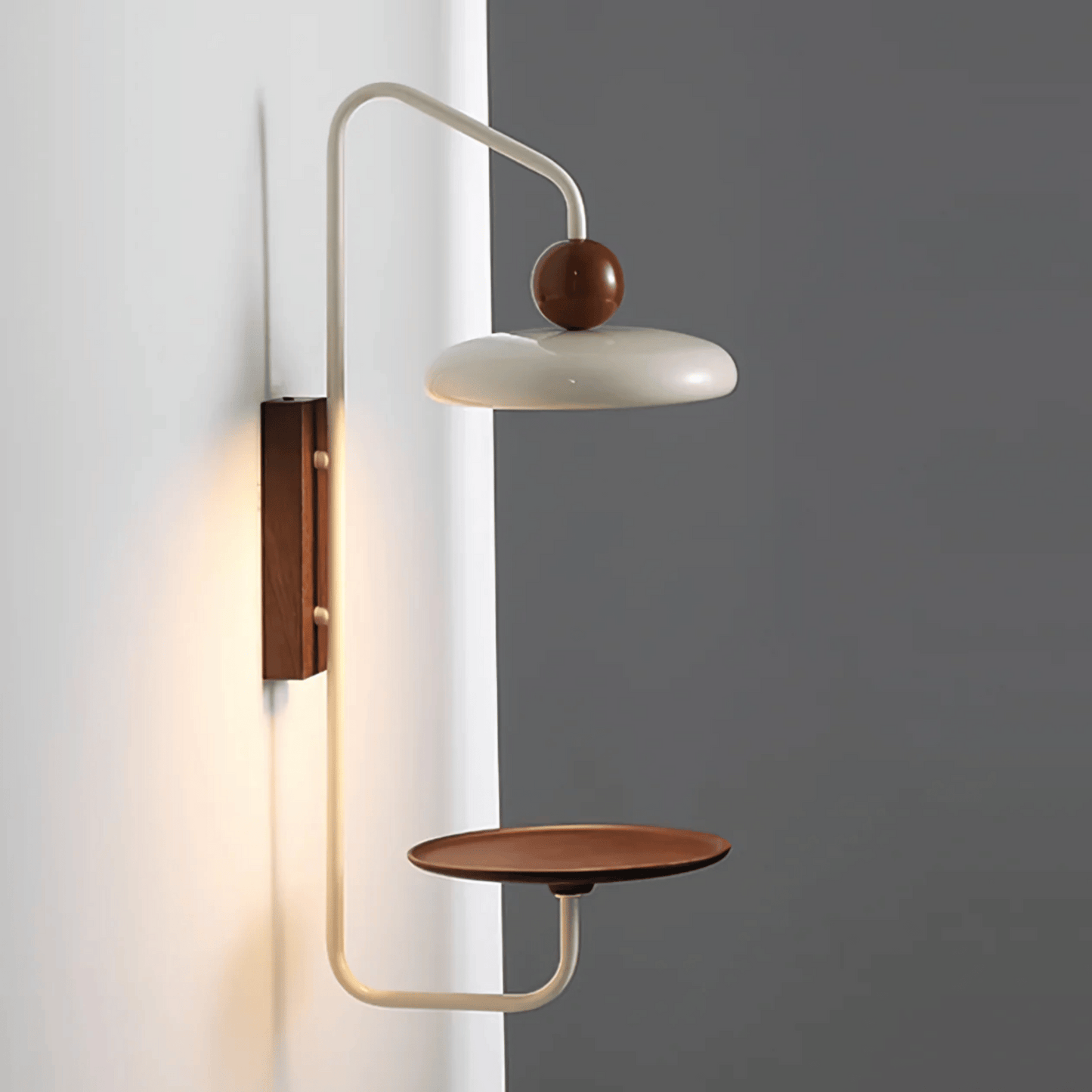 Modern wall lamp with a wooden base and white shade on a gray wall.