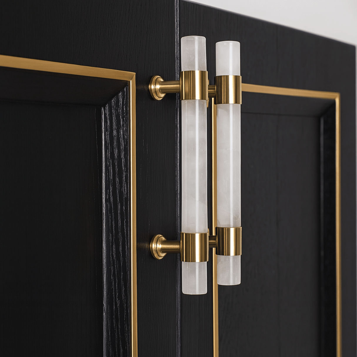 Decorative door handle with gold and clear glass design on a black door.