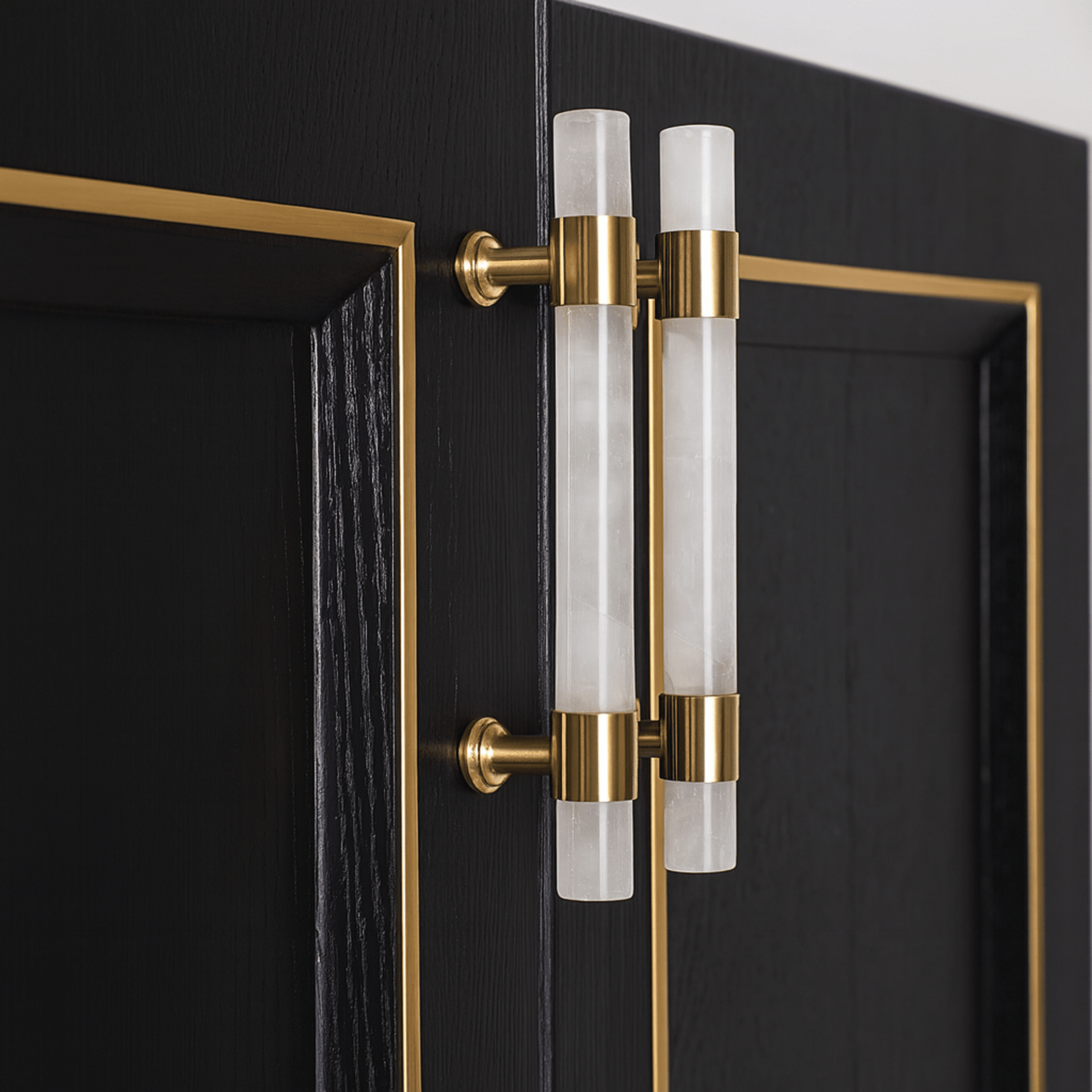 Decorative door handle with gold and clear glass design on a black door.
