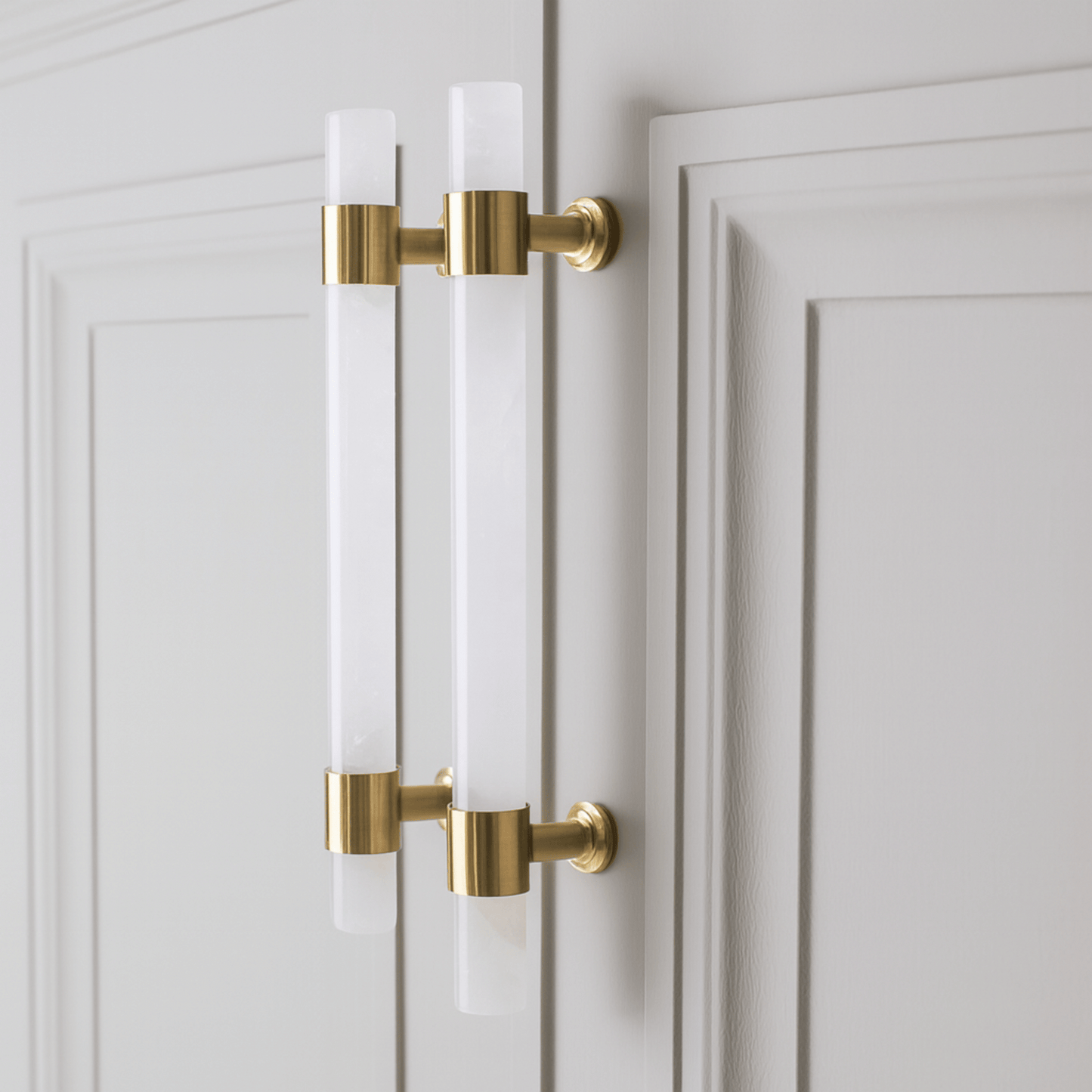 Gold cabinet handles on a white door