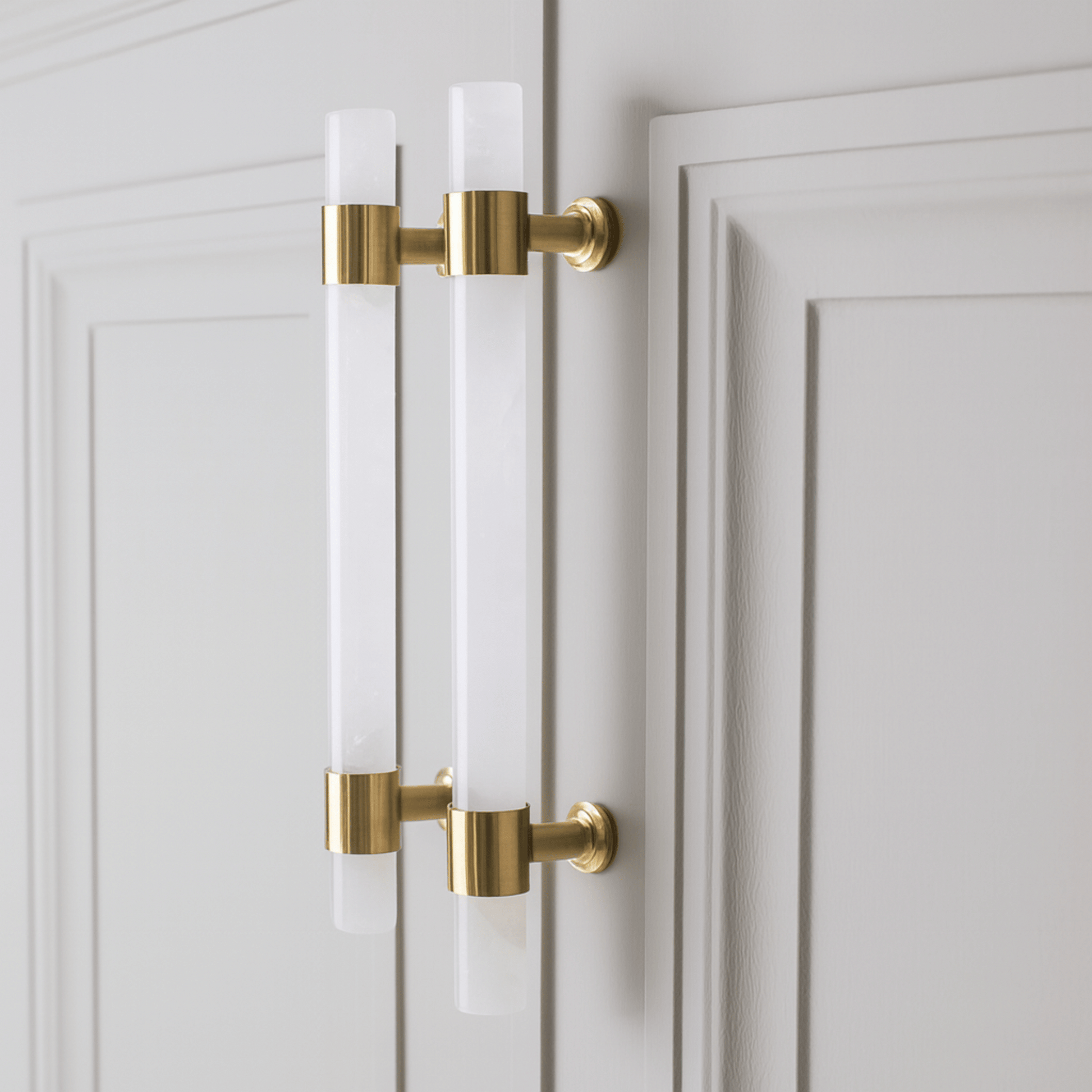 Gold cabinet handles on a white door