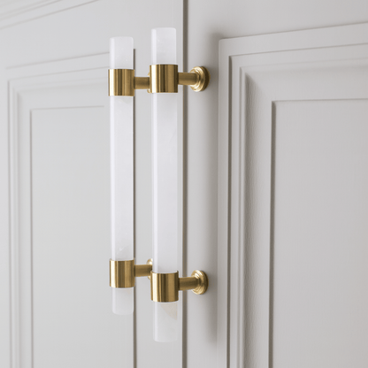 Gold cabinet handles on a white door