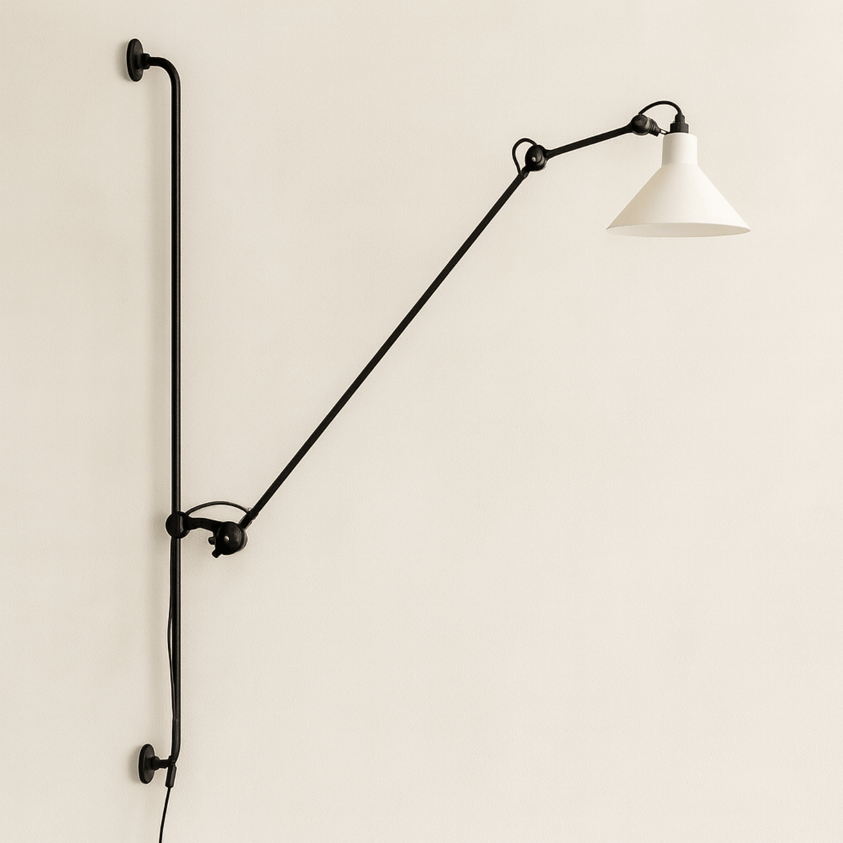 Wall-mounted lamp with a long arm and white shade on a beige wall