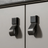 Metallic cabinet handles on a light gray cabinet door
