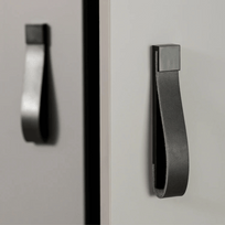 Black cabinet handle on a gray cabinet door