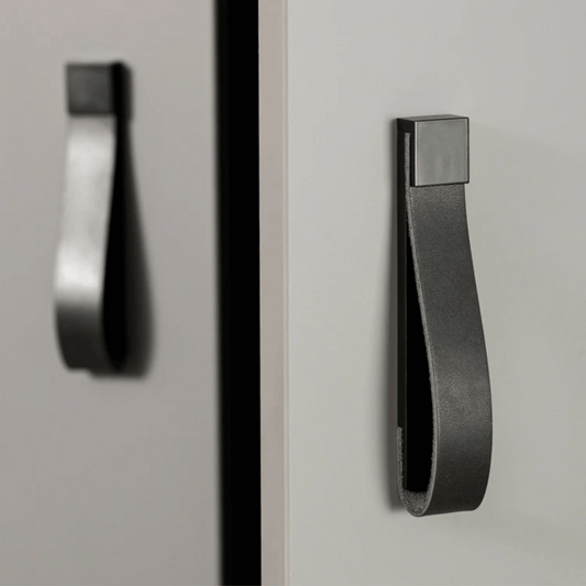 Black cabinet handle on a gray cabinet door