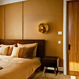 Bedroom with brown walls, bed, and nightstand.