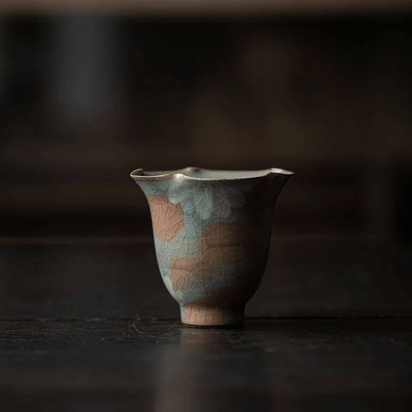 Ceramic cup with floral patterns on a dark background