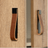 Close-up of wooden furniture with leather handles on a light wood background