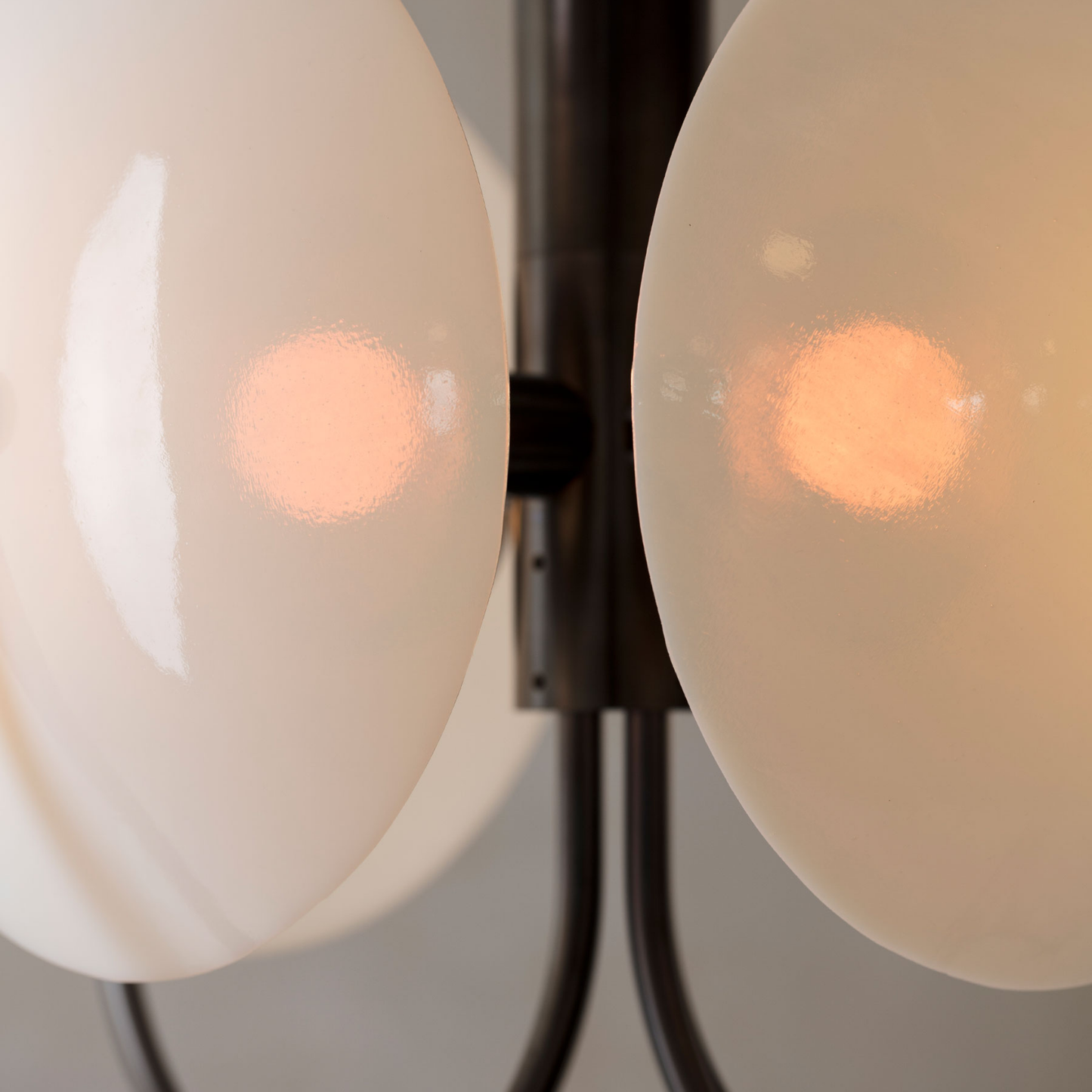Close-up of a chandelier with two illuminated light bulbs.