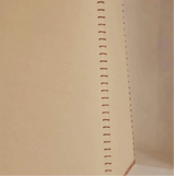 Close-up of a beige fabric with a vertical stitching pattern
