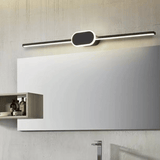 Modern wall-mounted light fixture above a mirror in a bathroom setting.