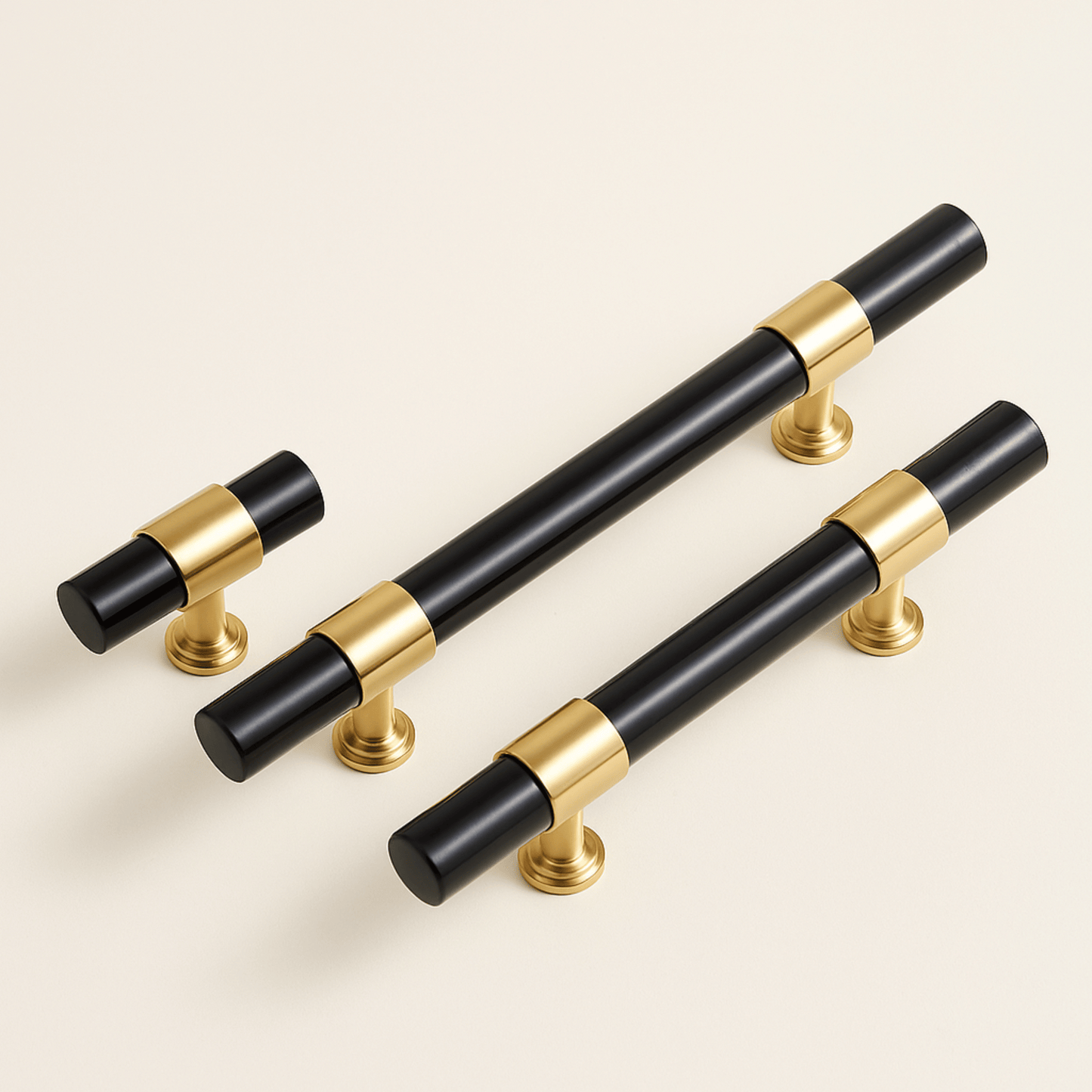 Set of black and gold cabinet handles on a light beige background
