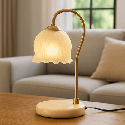 Table lamp with a decorative shade on a wooden table in a living room setting.