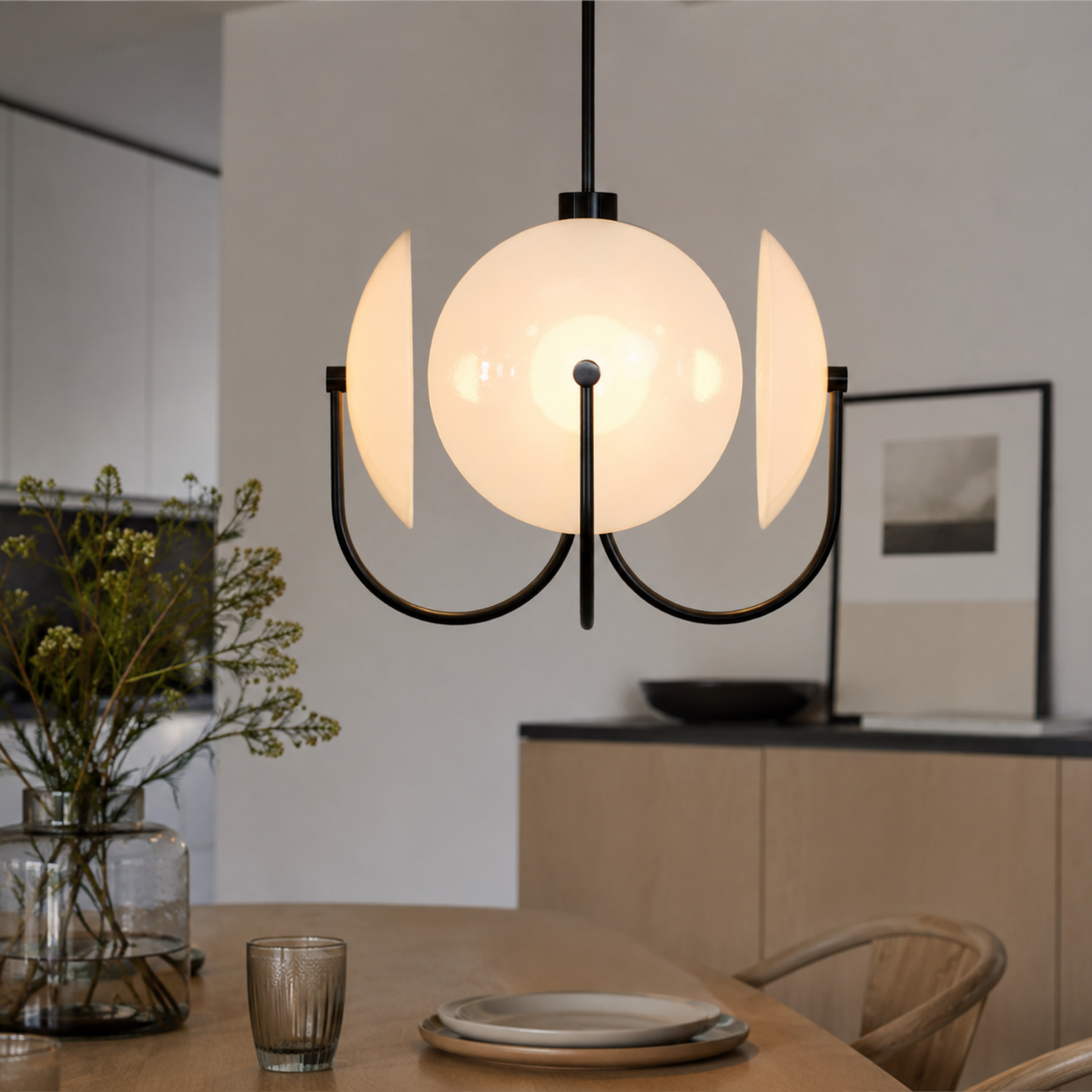 Modern pendant light hanging above a dining table with a neutral background