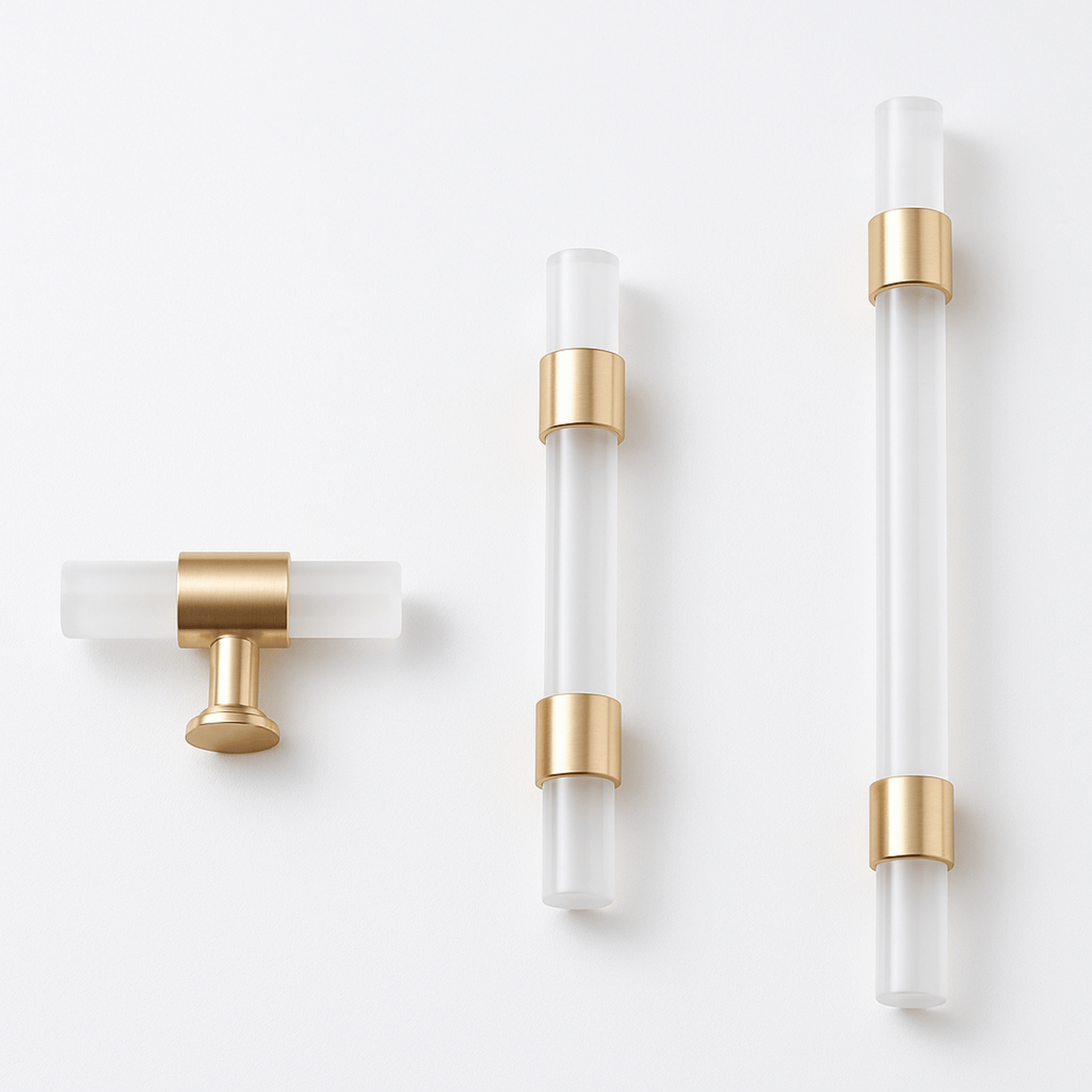 Set of three modern wall sconces with gold accents on a white background