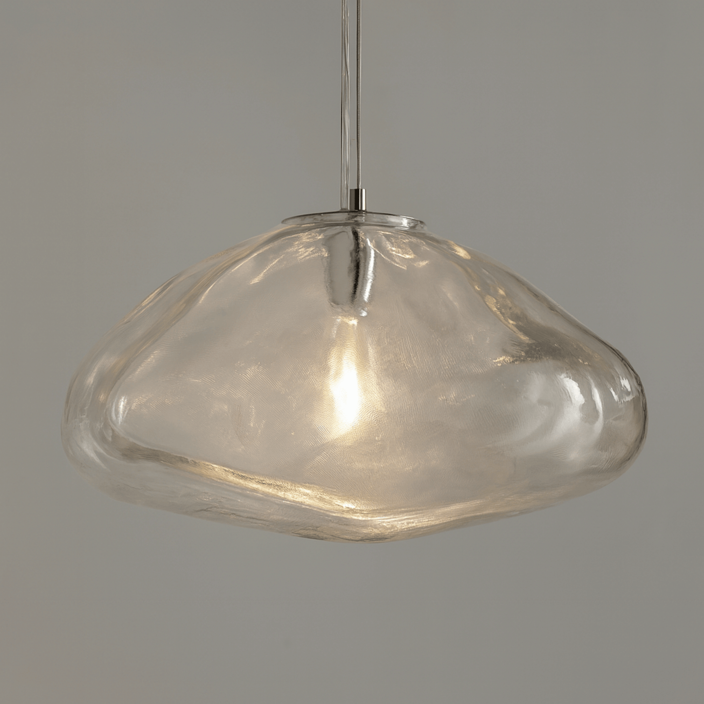 Clear glass pendant light on a gray background