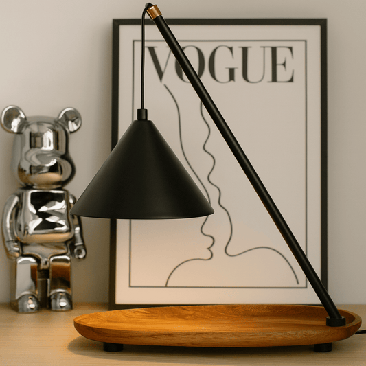 Black lampshade on a wooden base with a 'VOGUE' poster in the background