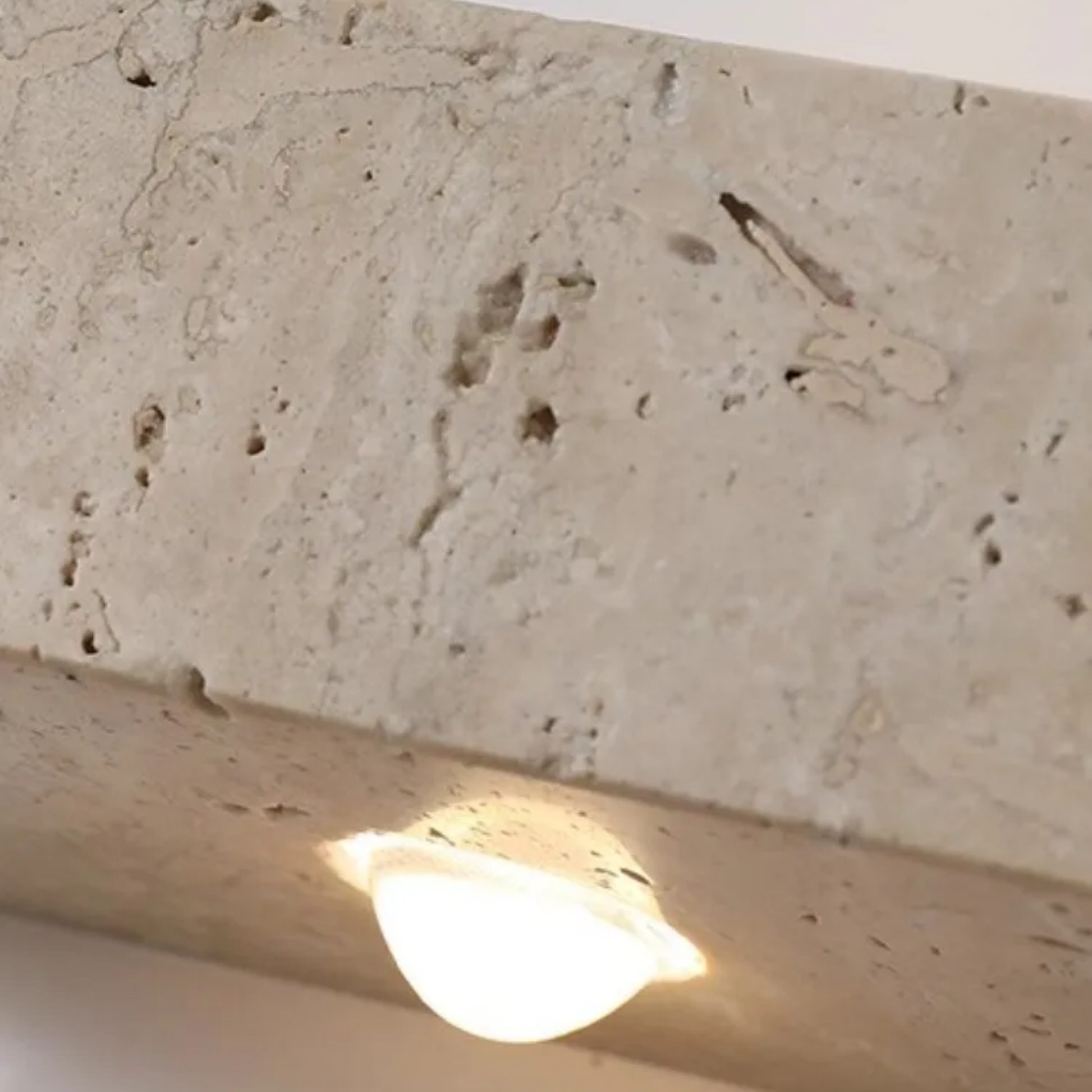 Light bulb on a textured stone surface