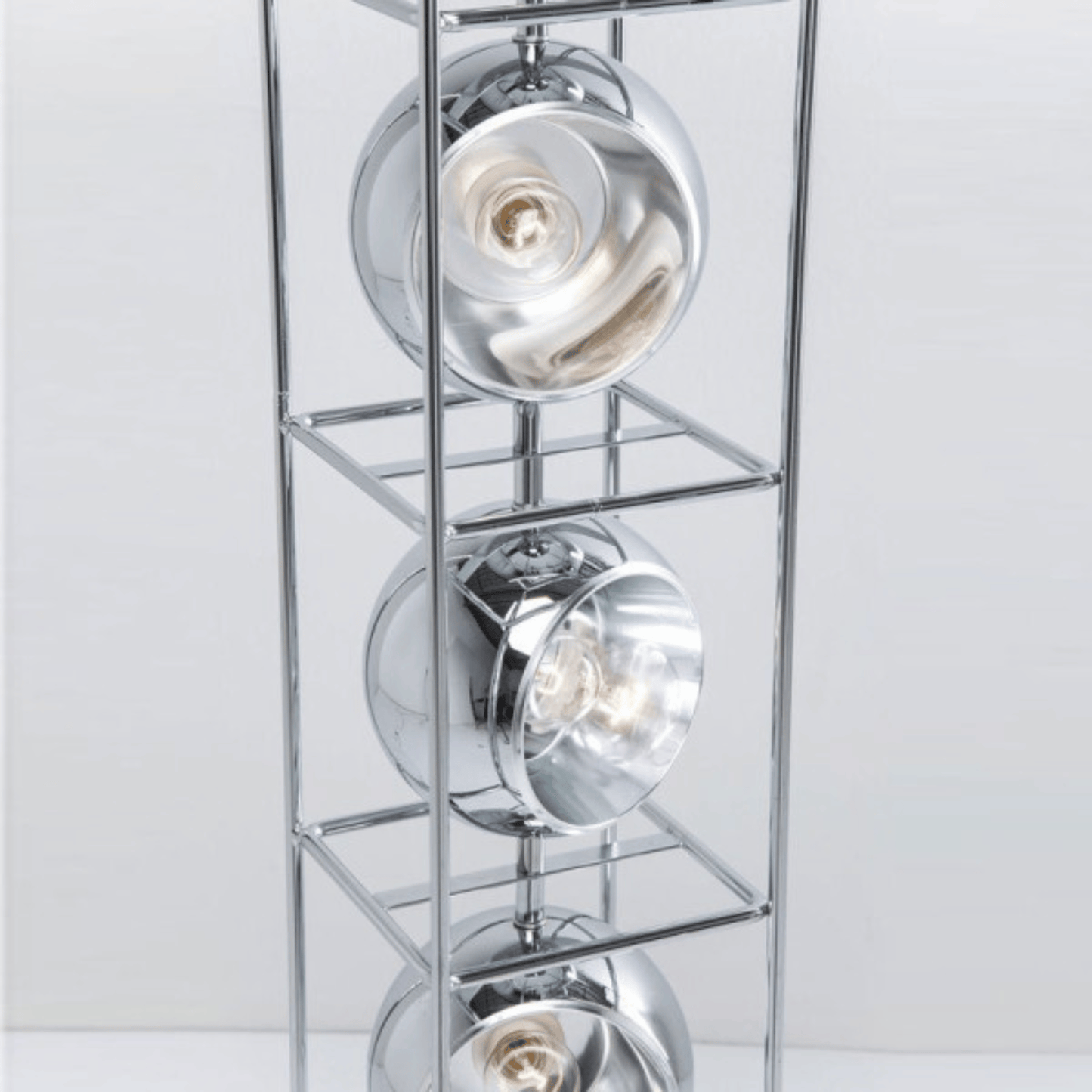 Chrome ceiling light fixture with three circular lights on a white background