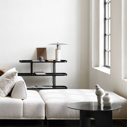 Minimal white bedroom with a bamboo lamp on a sleek side table beside a modern chair