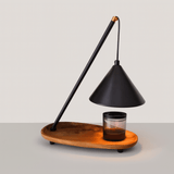 Modern lamp with wooden base and black shade on a light gray background
