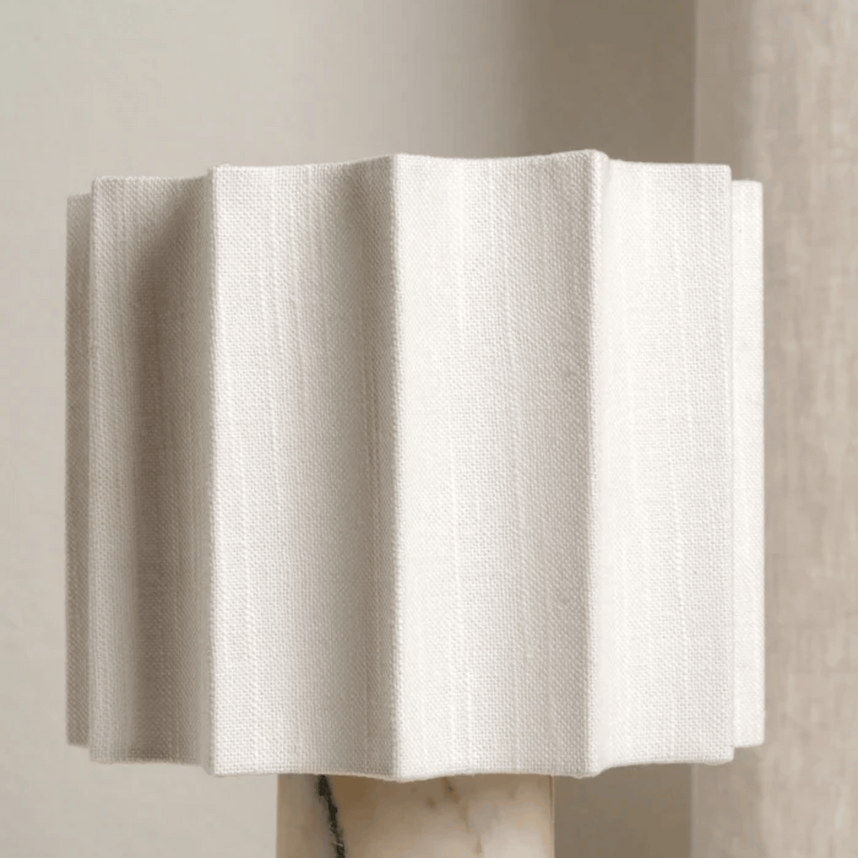White textured wall art piece on a neutral background