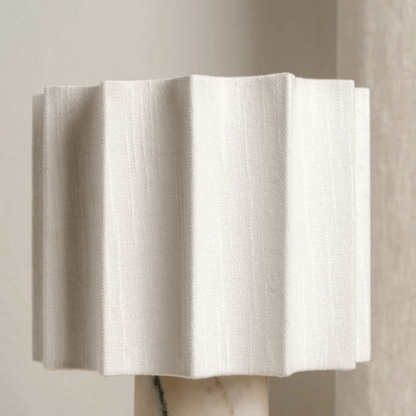 White textured wall art piece on a neutral background