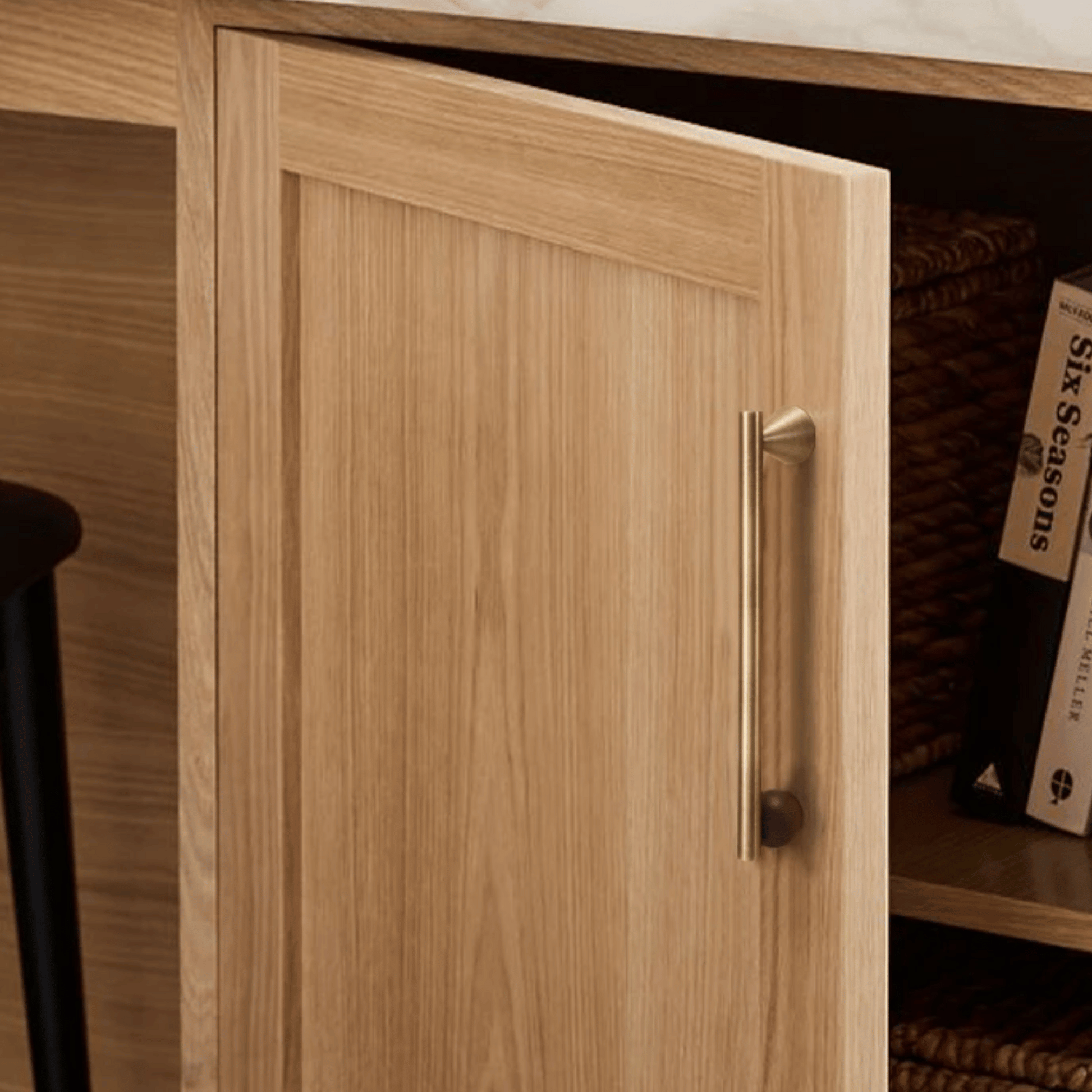 Wooden cabinet door with a handle, part of a larger wooden structure.