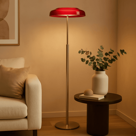 Living room with a red floor lamp, beige sofa, and small table with a plant.