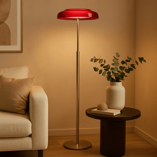 Living room with a red floor lamp, beige sofa, and small table with a plant.