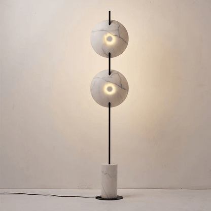 Modern floor lamp with marble-like design on a plain background