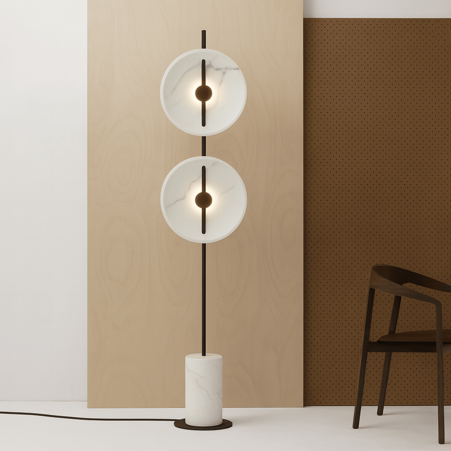 Modern floor lamp with two circular glass shades in a minimalistic room.