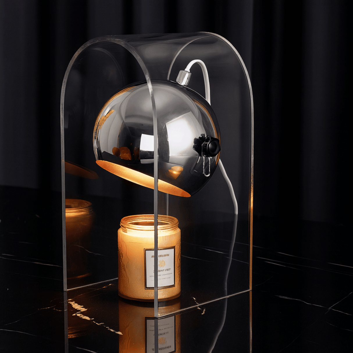 Candle in a glass holder on a dark surface