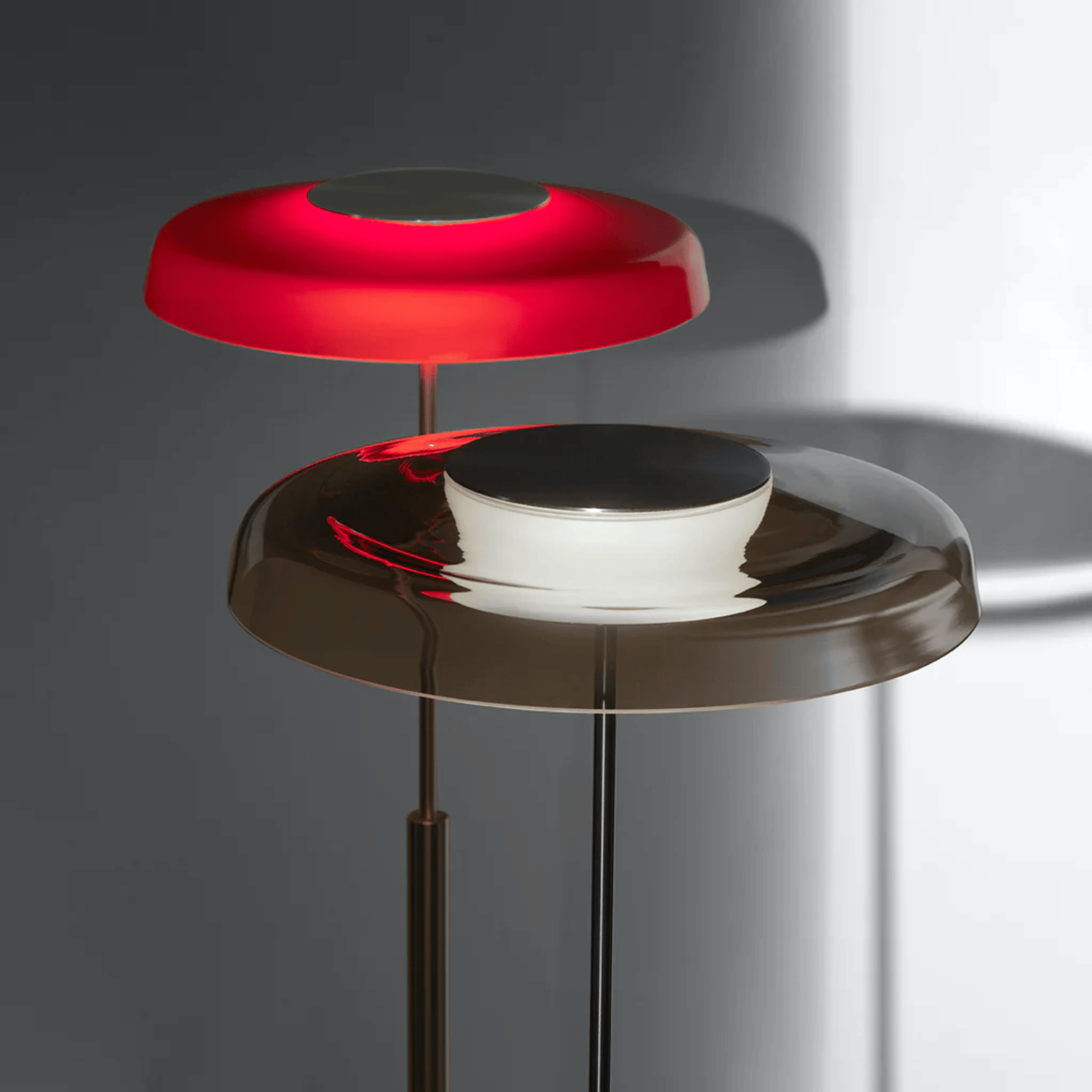 Modern floor lamp with red and black design on a gray background