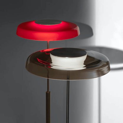 Modern floor lamp with red and black design on a gray background