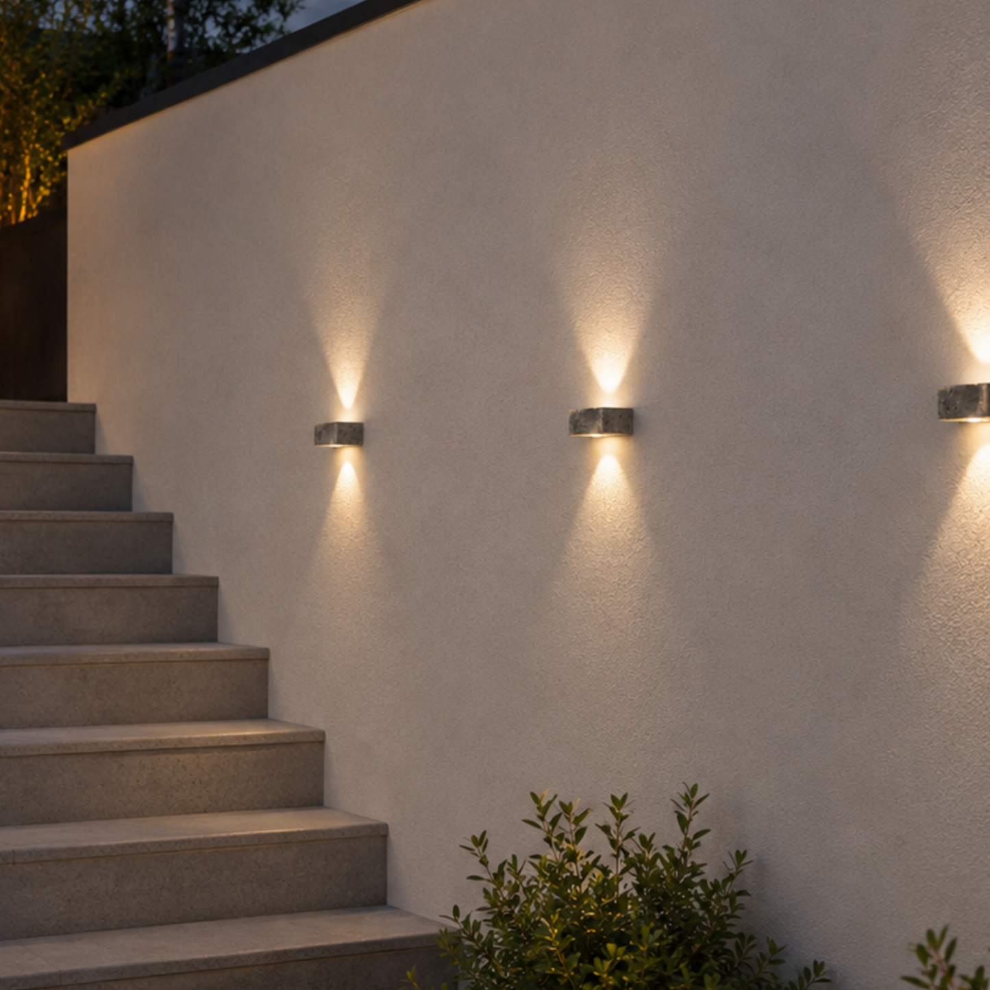 Outdoor wall lights illuminating a staircase against a light-colored wall.