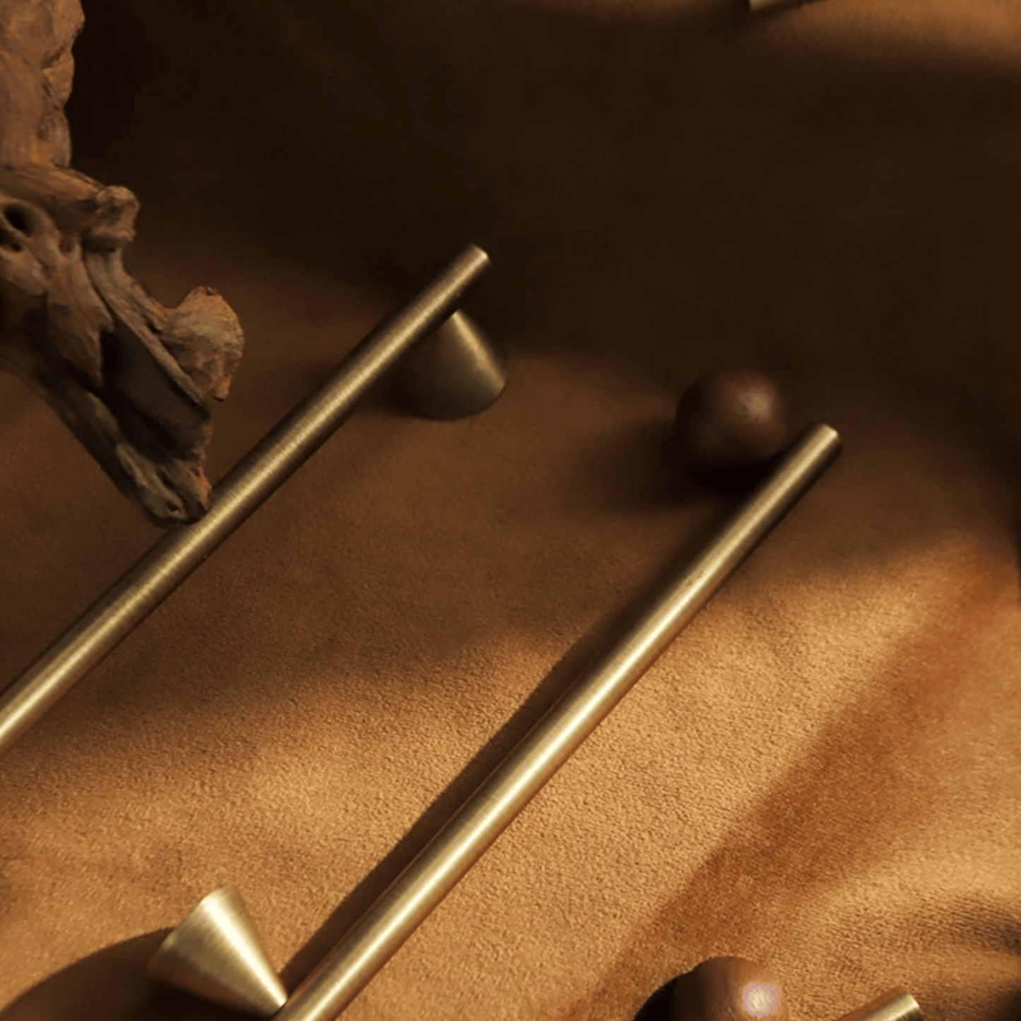 Close-up of gold handles on a textured brown surface