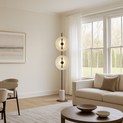 Modern living room with a floor lamp, sofa, and round coffee table.