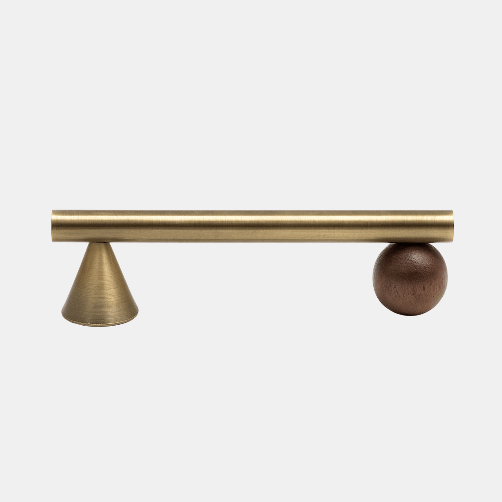 Brass curtain rod with a brown ball finial on a white background