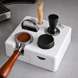 Coffee grinder with various attachments on a gray surface